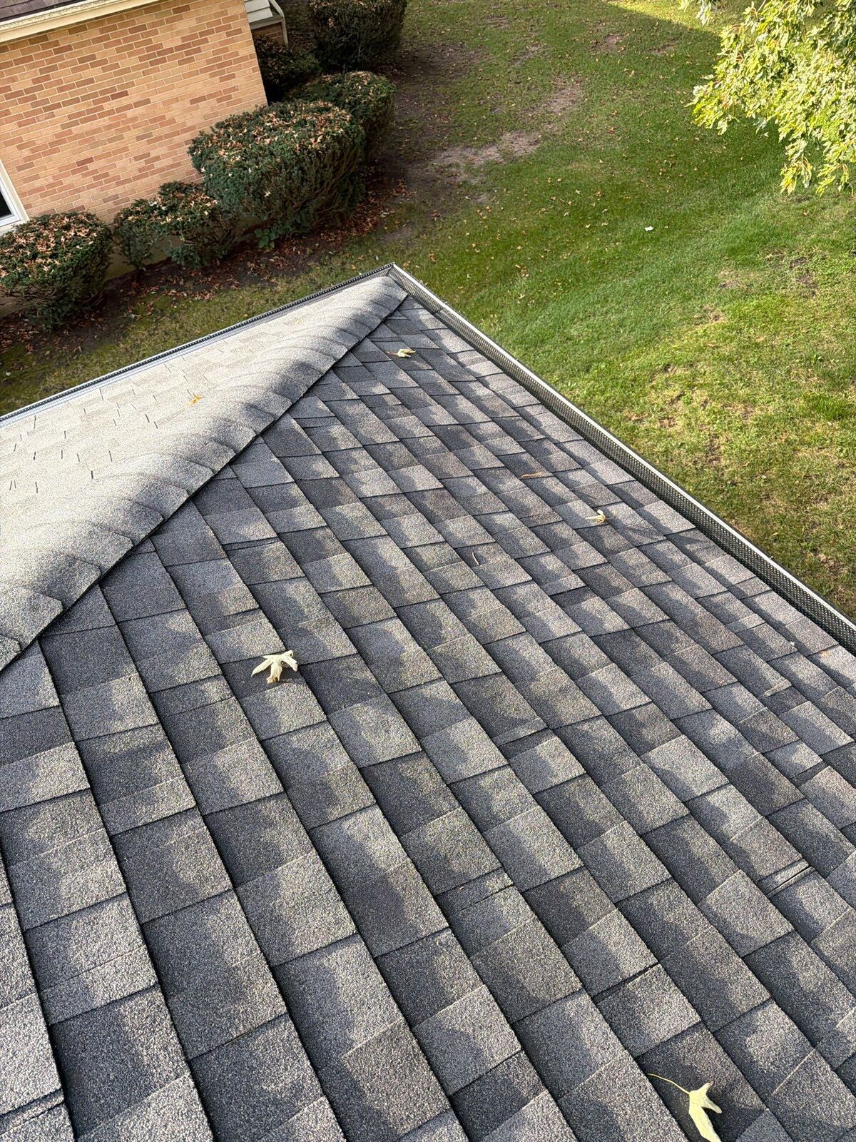 Shingled roof hip inspected for storm and hail damage