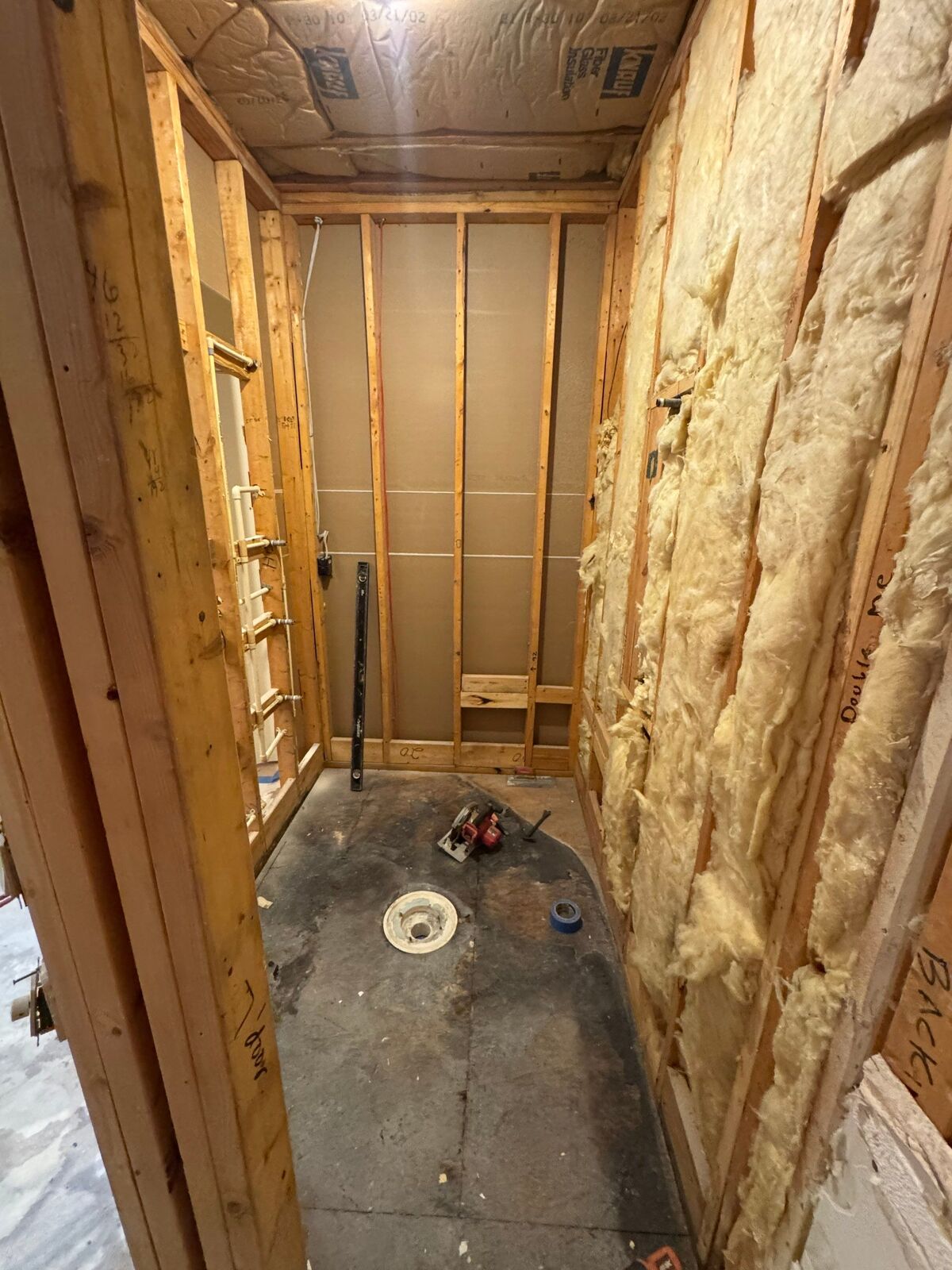 Room stripped to the wall studs and insulation during repairs